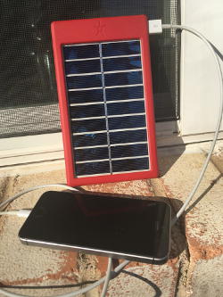 Solar Phone Charger in sun with iPhone